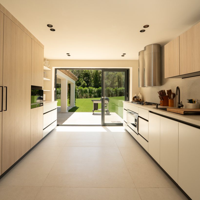 Full-height Vicenza oak cabinetry with integrated oven — Villa Carpe Diem, Saint-Tropez
